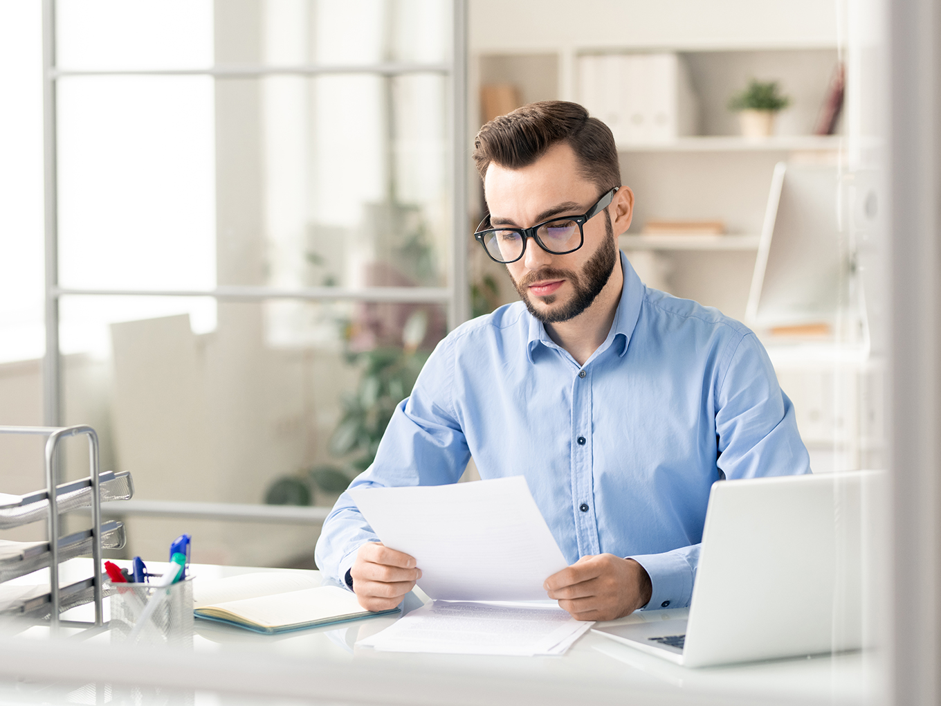 Young man reading a finance document Young man reading a finance document